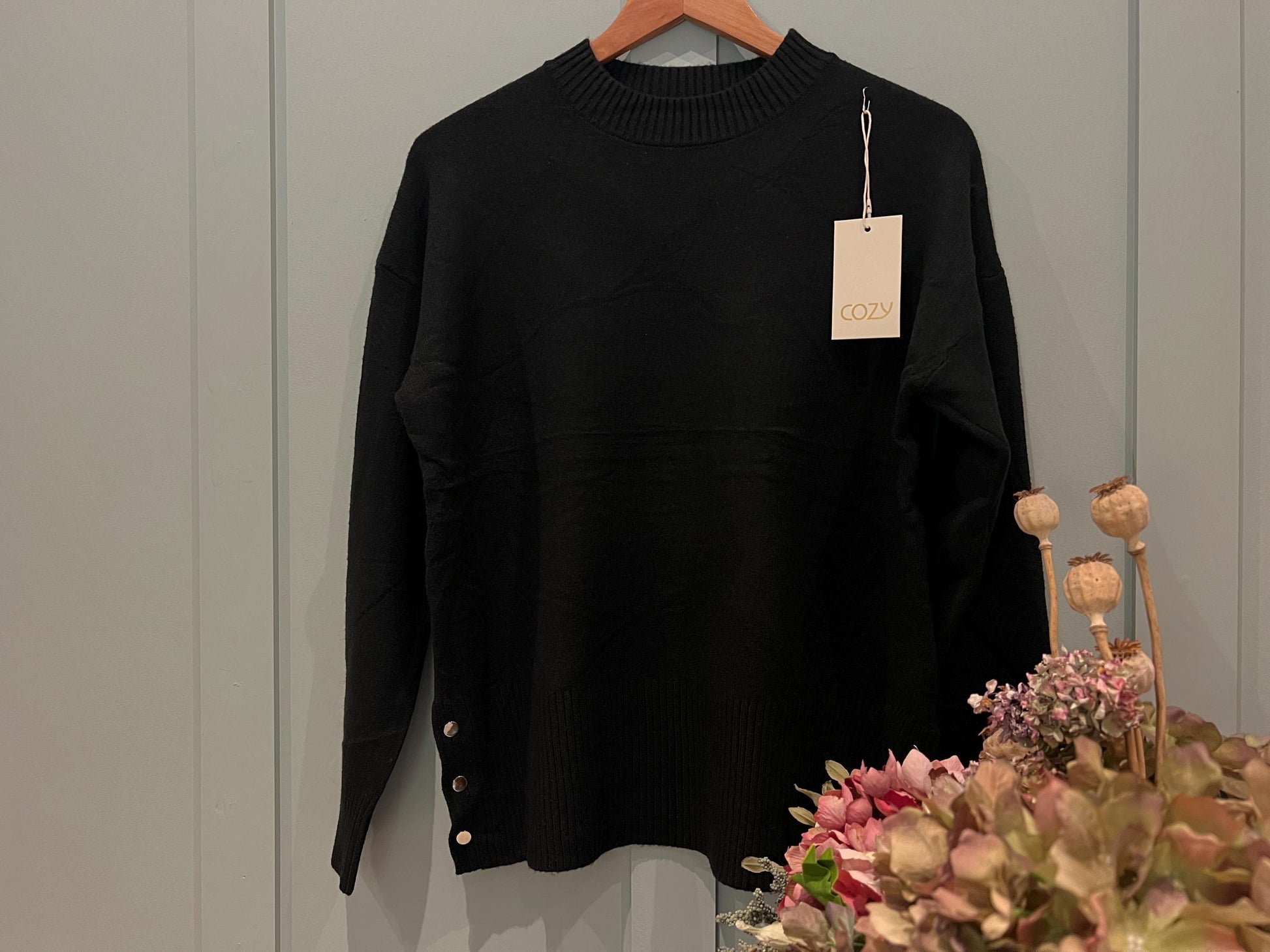 Black Ladies Jumper with Button Side Detailing. Stunning jumper with buttons on the side, One size fits most, Long Sleeved.