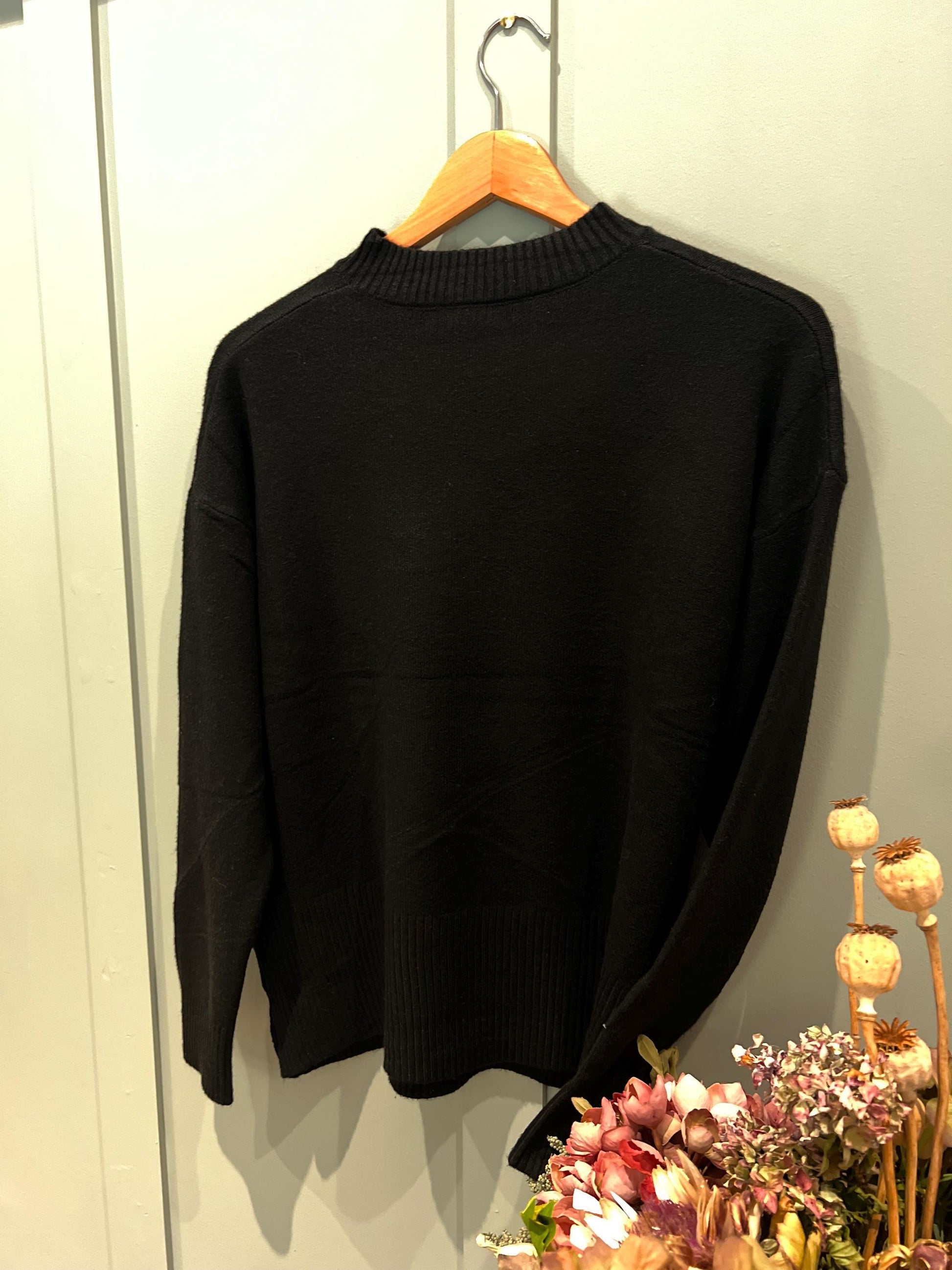 Black Ladies Jumper with Button Side Detailing. Stunning jumper with buttons on the side, One size fits most, Long Sleeved.