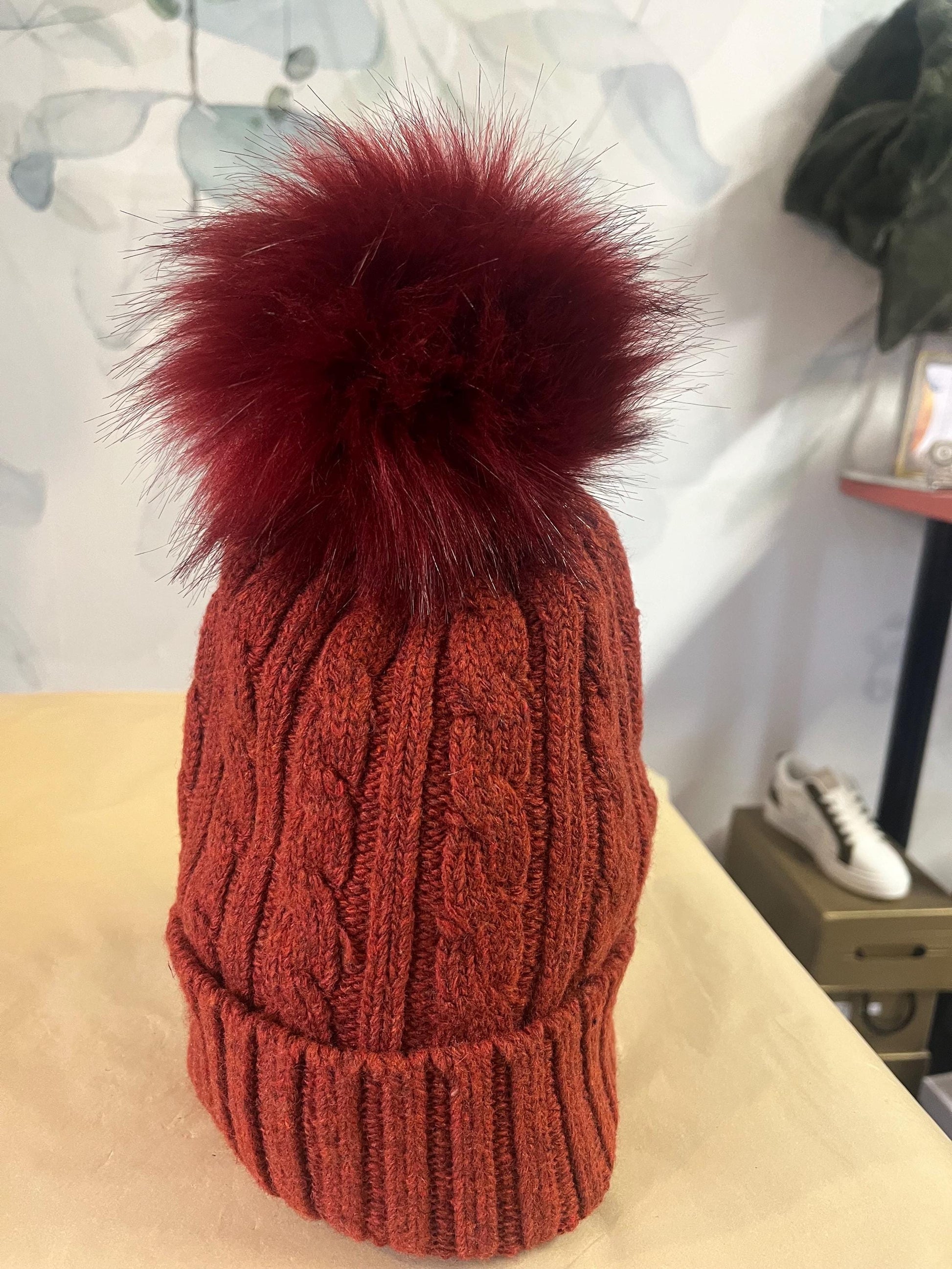 Cable knit hat with faux fur pompom