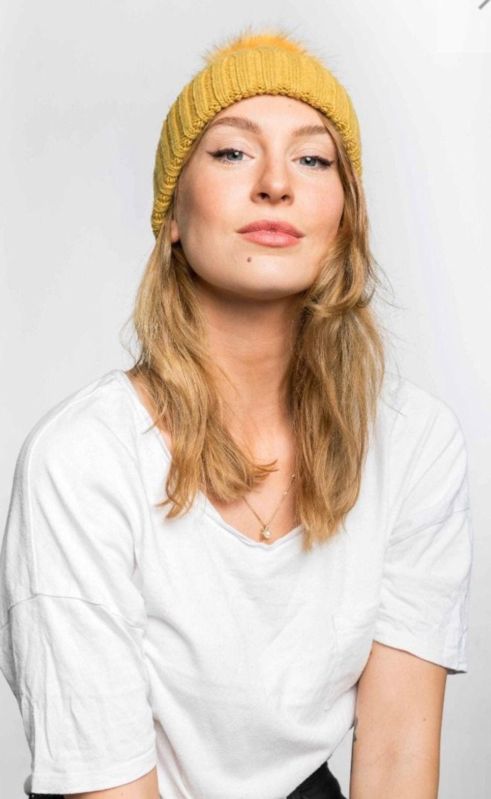 Cable knit hat with faux fur pompom