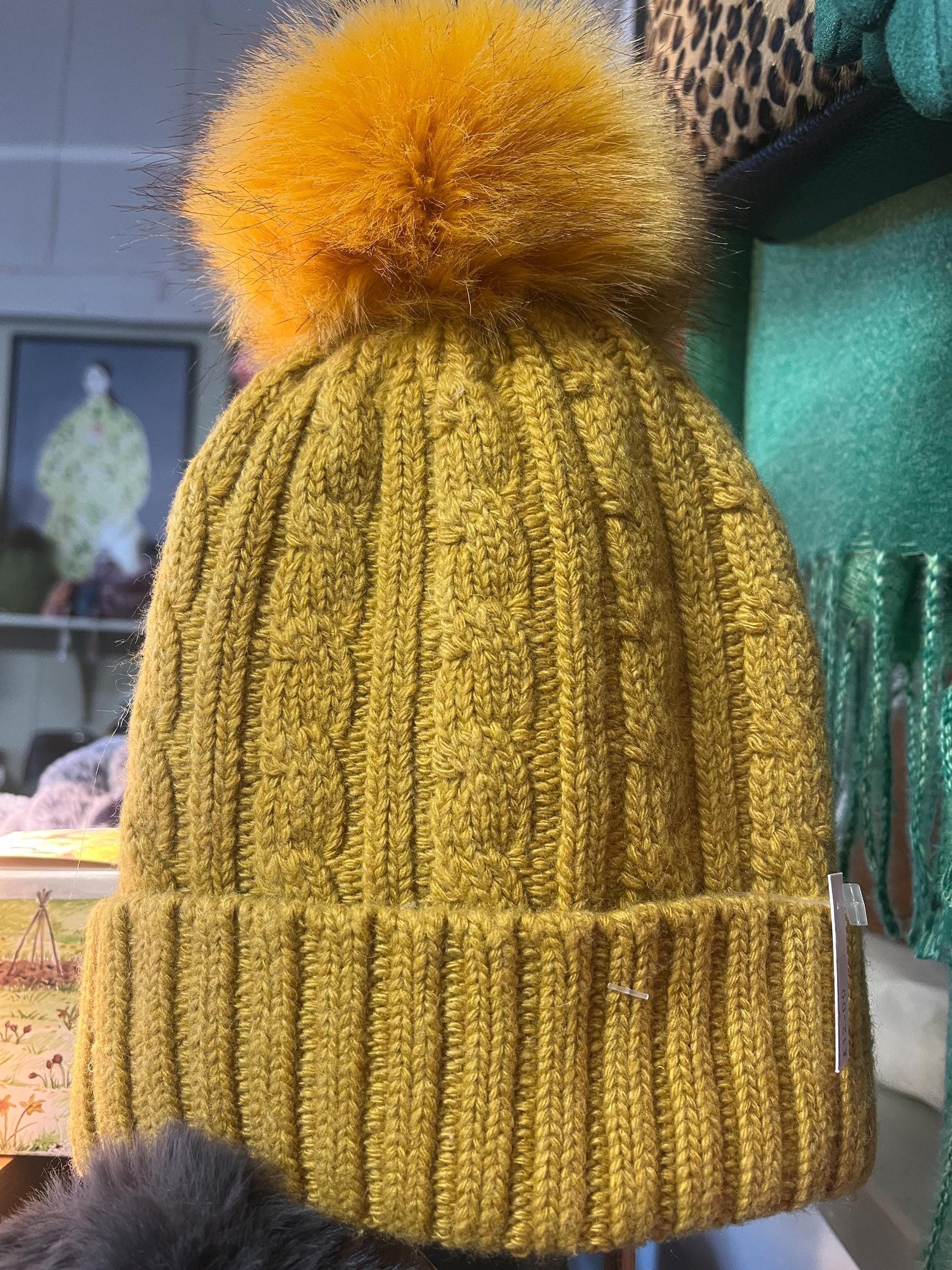 Cable knit hat with faux fur pompom