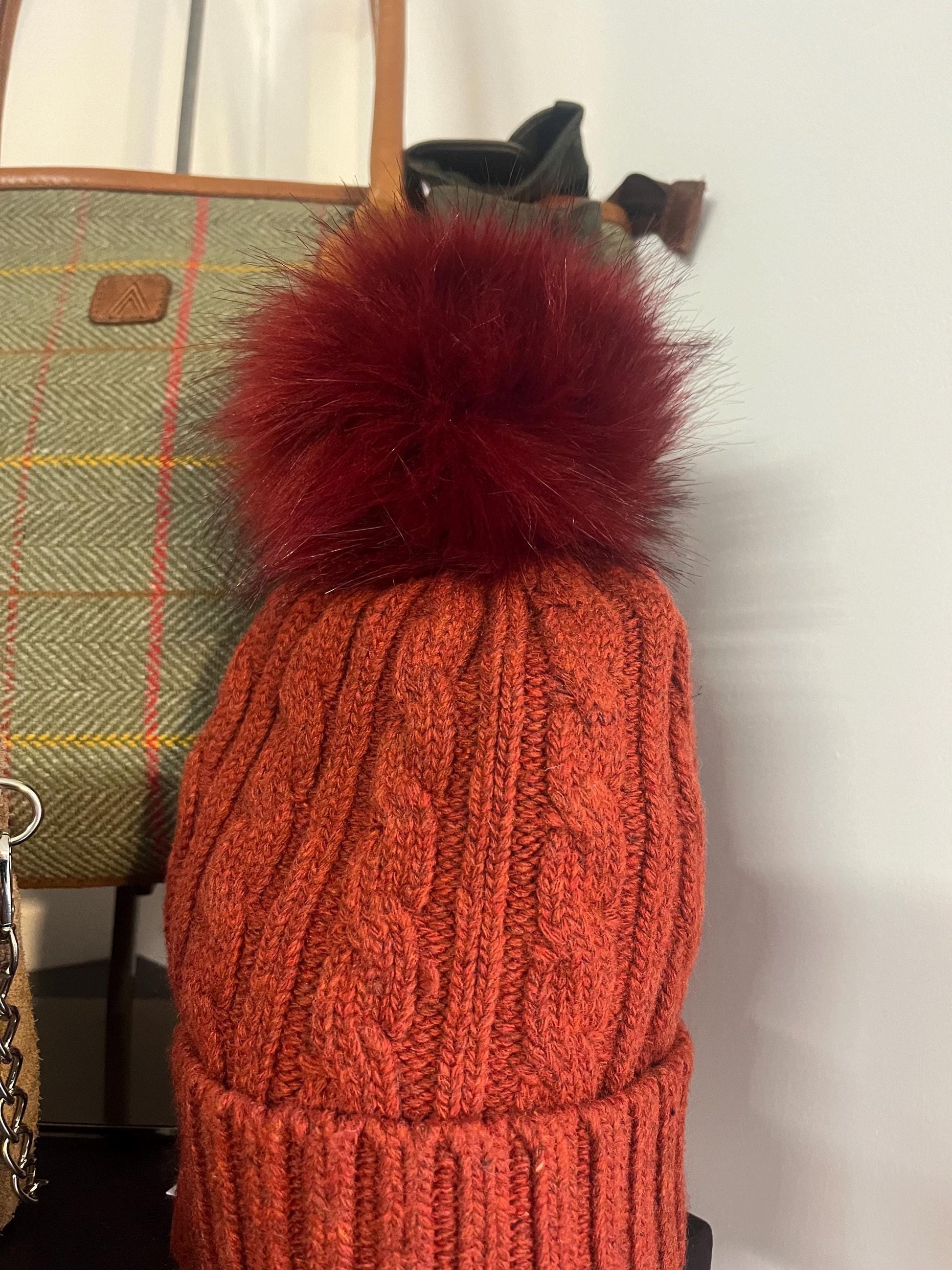 Cable knit hat with faux fur pompom